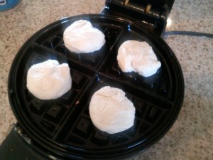 Halved Grands biscuits on waffle maker