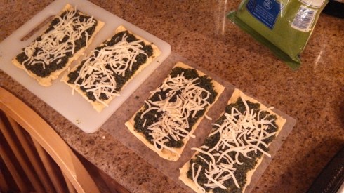 Spread pesto on unrolled crescent rolls